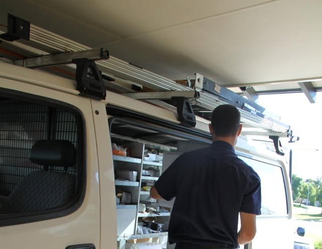 Troy restocking the shelves of his fitted-out work van